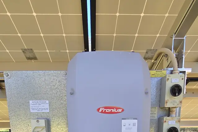 A solar inverter and isolators installed under a solar array